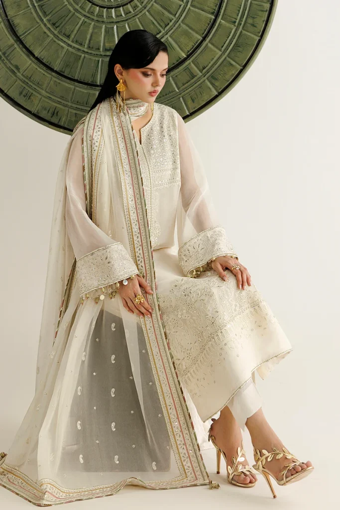Model wearing a white embroidered outfit from Kashfiya